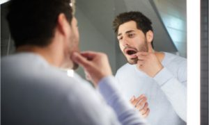 The man needs home remedies for gum pain.